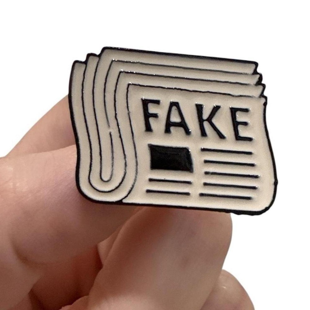 "Fake News" enamel pin black and white newspaper